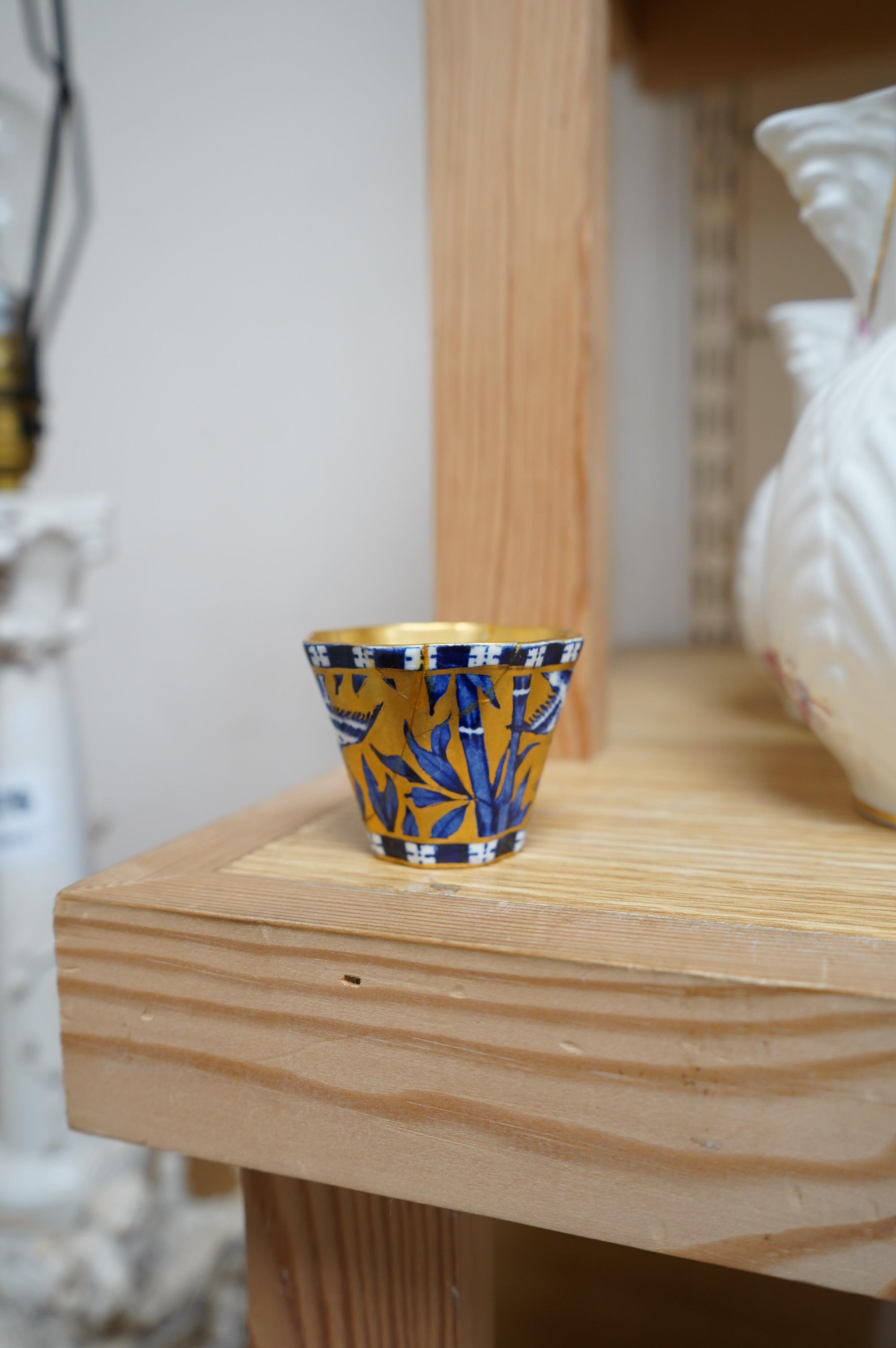 A set of six Coalport blue, gilt and white octagonal coffee cups and saucers, (three cups cracked), and two modern Coalport “Caughley Mask’’ jugs, (14), tallest 14.5cm. Condition - varies